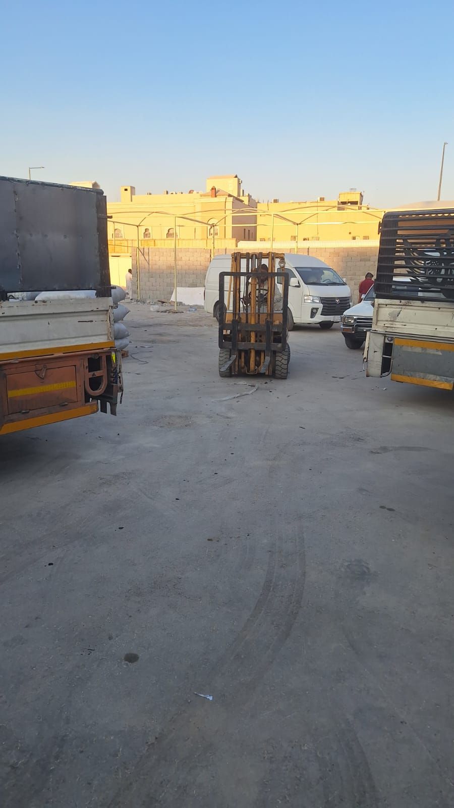 Forklift and trucks in the loading yard